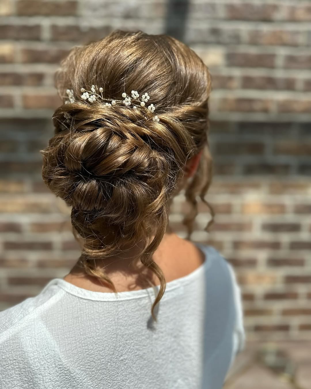Voluminous High Messy Bun with Hair Vine